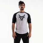 Man wearing a white and black sports jersey with a logo on a white background

