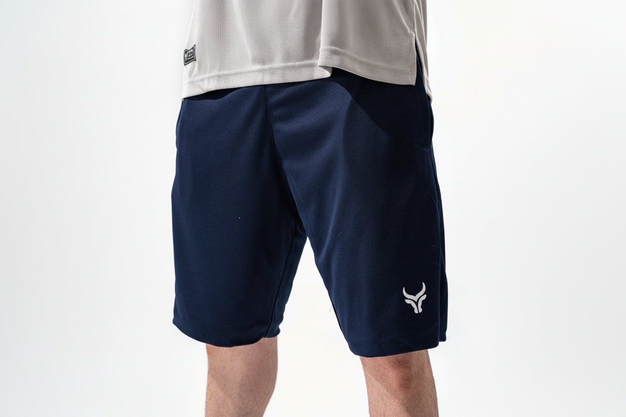 Navy athletic shorts with a logo on a white background