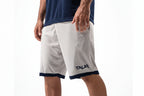 Person wearing white shorts with navy accents and 'TAUR' branding on a white background