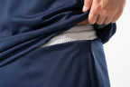 Navy blue fabric with a hand adjusting it, on a white background