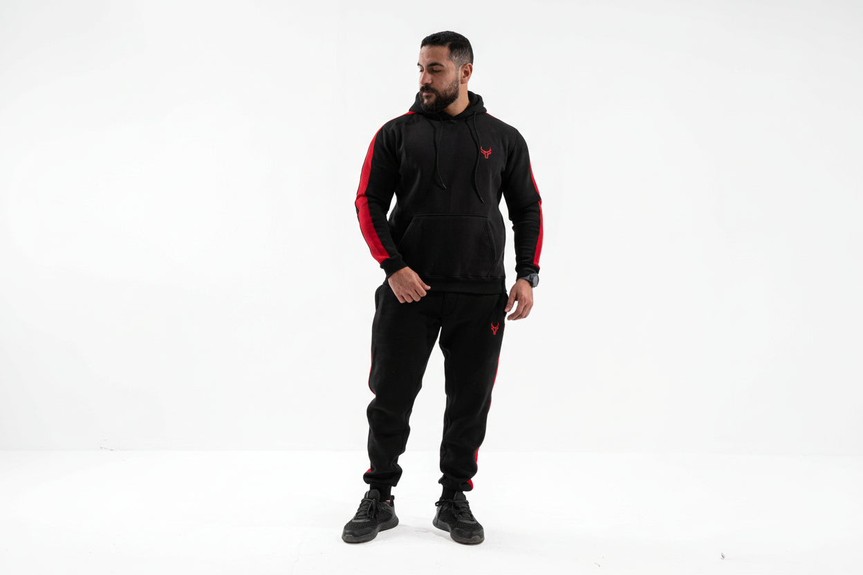 Man wearing a black and red tracksuit on a white background

