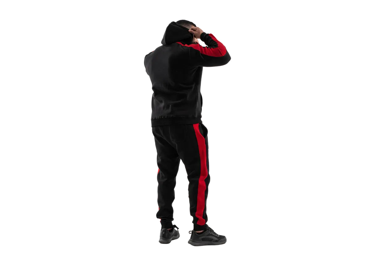 Person wearing a black and red tracksuit on a white background

