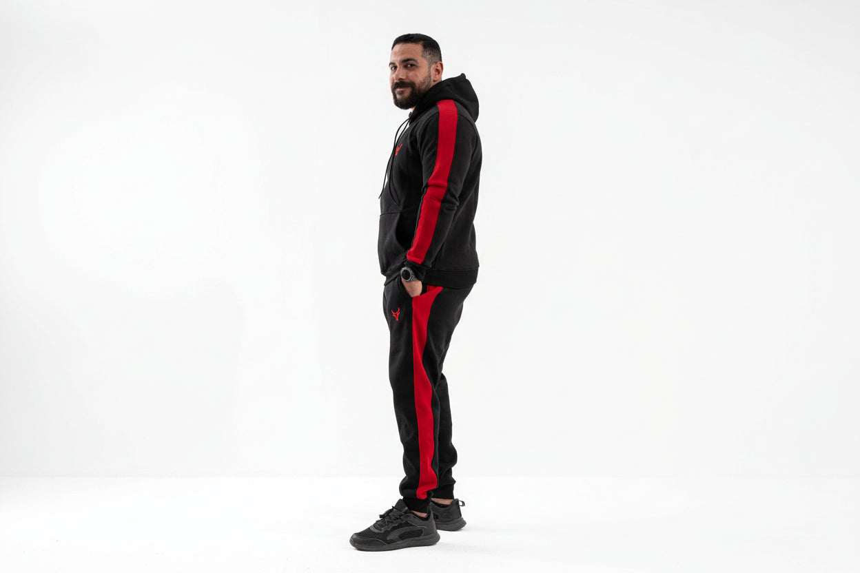 Man wearing a black and red tracksuit on a white background

