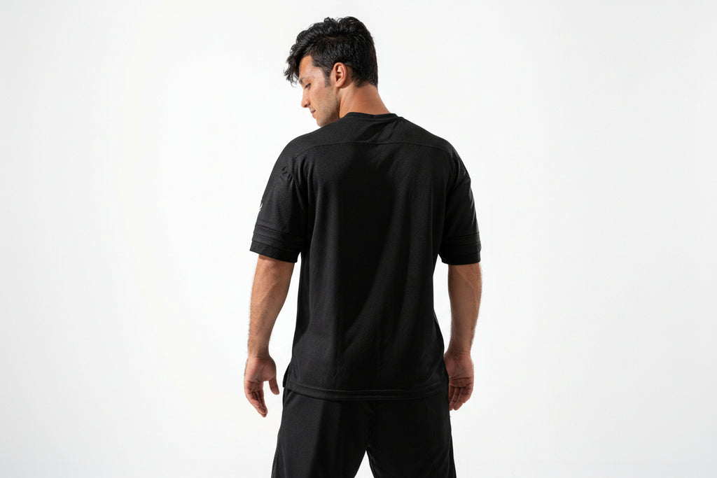 Man wearing a black athletic outfit on a white background