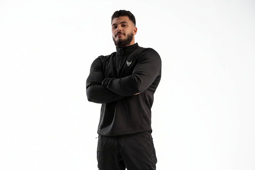 Man wearing a black jacket with a logo on a white background