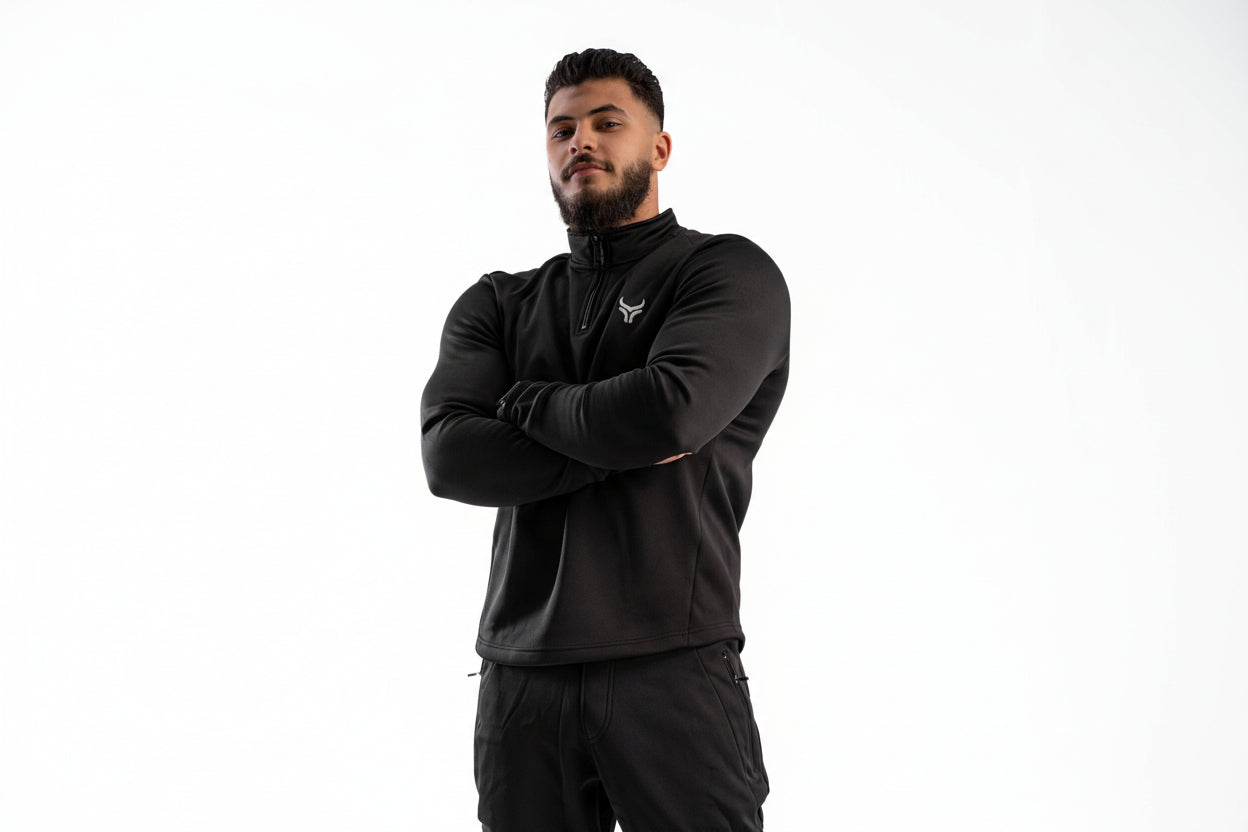 Man wearing a black jacket with a logo on a white background