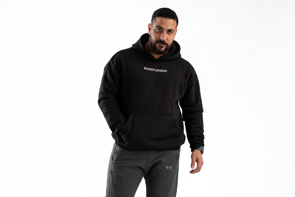 Man wearing a black hoodie with 'BOOSTER' logo on a white background

