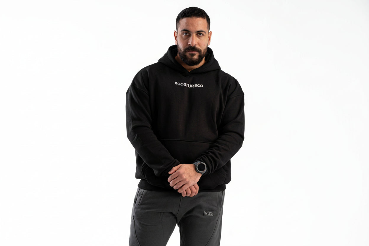 Man wearing a black hoodie with 'BOOSTUREGO' logo on a white background

