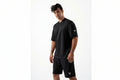 Man wearing a black athletic outfit with a logo on a white background