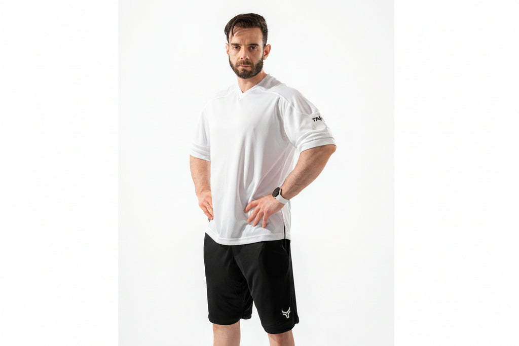 Man wearing a white t-shirt and black shorts on a white background