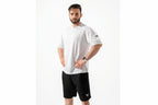 Man wearing a white t-shirt and black shorts on a white background