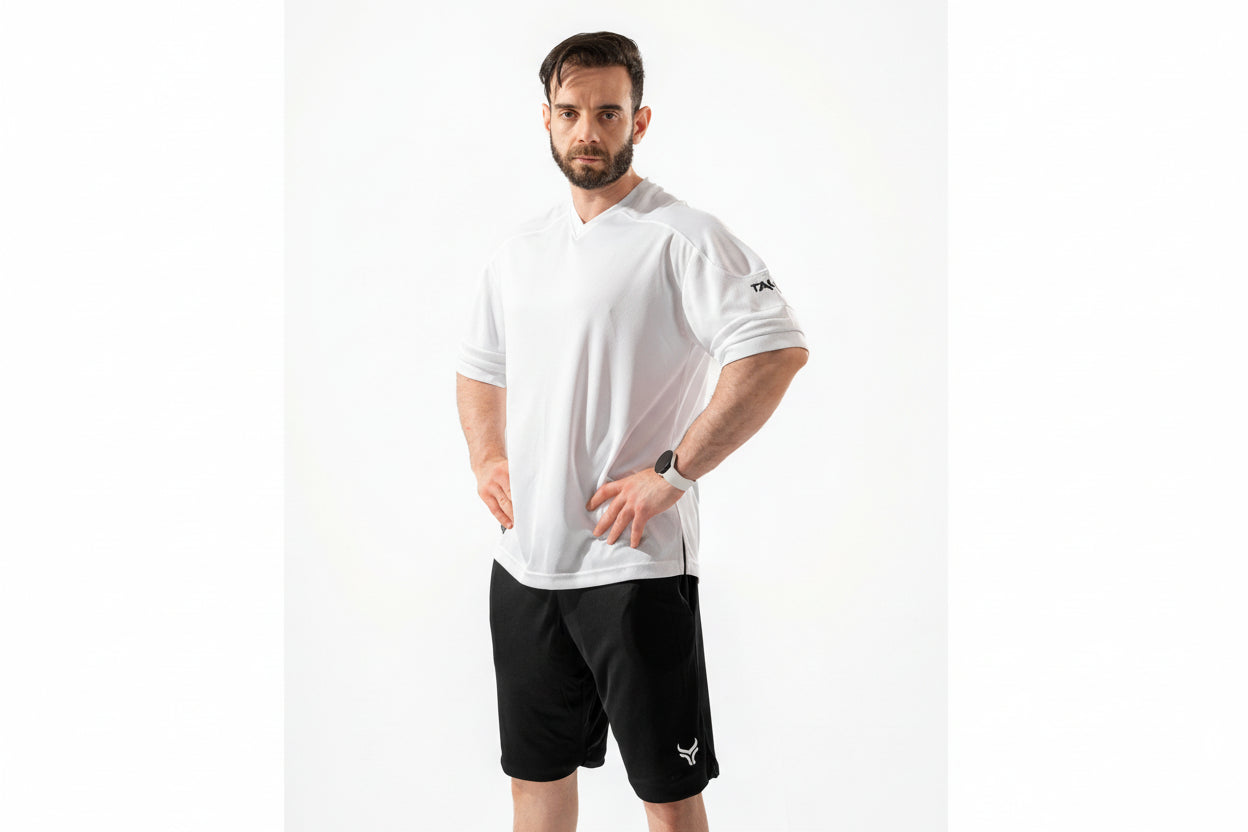 Man wearing a white t-shirt and black shorts on a white background