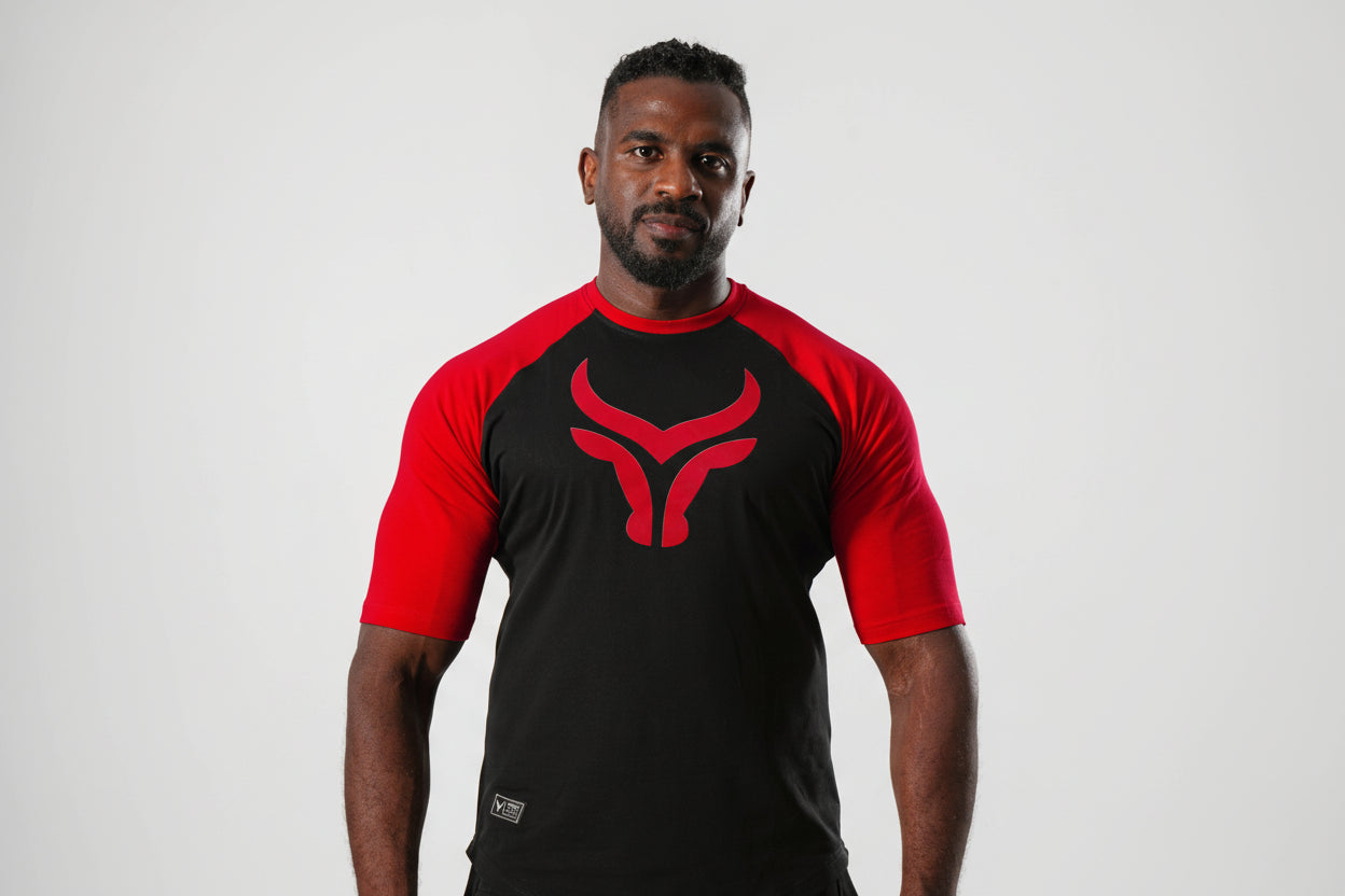 Man wearing a black and red athletic outfit with a logo on a white background

