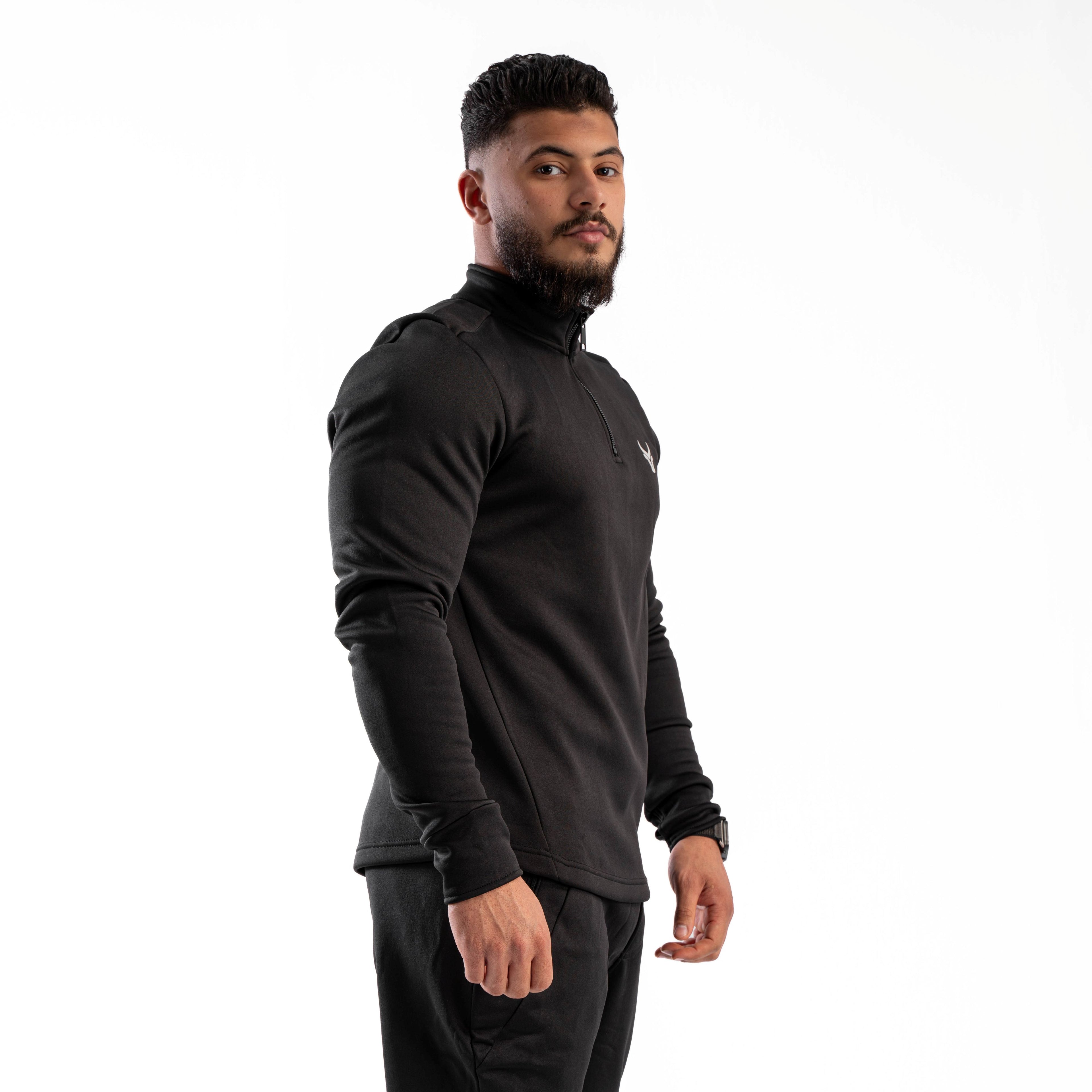 Man wearing a black long-sleeve athletic shirt on a white background