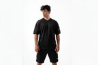 Man wearing a black sports outfit with a logo on a white background