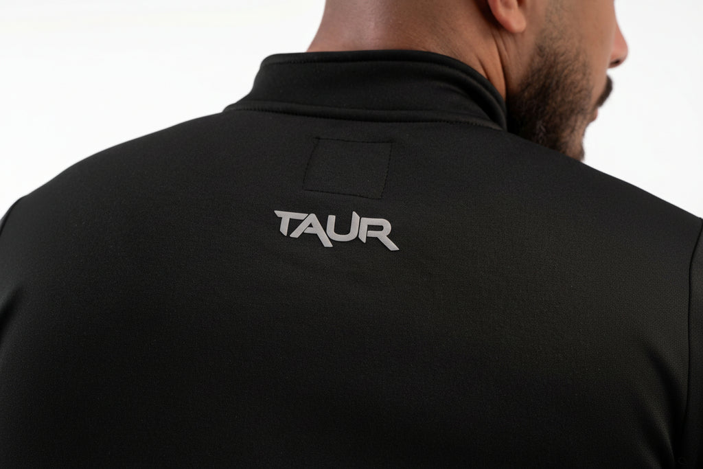 Black jacket with 'TAUR' logo on the back against a white background