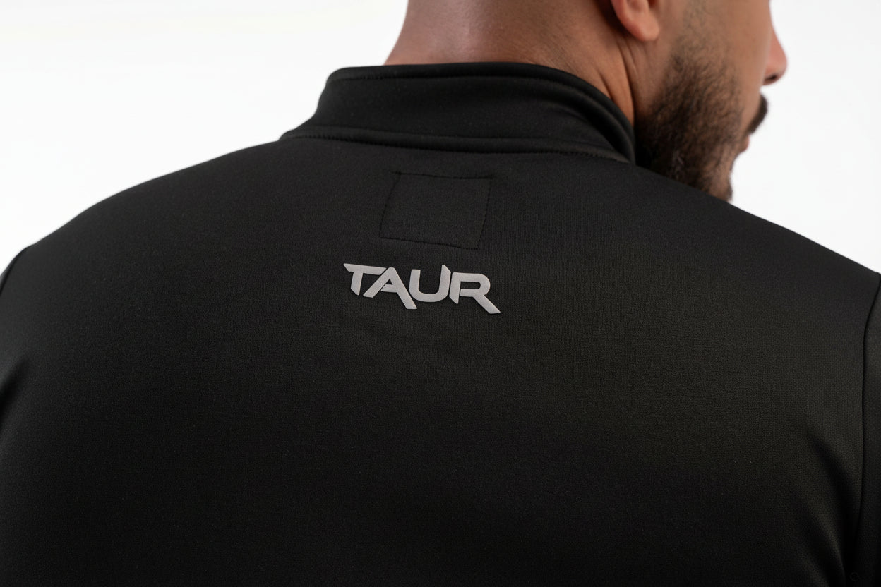Black jacket with 'TAUR' logo on the back against a white background