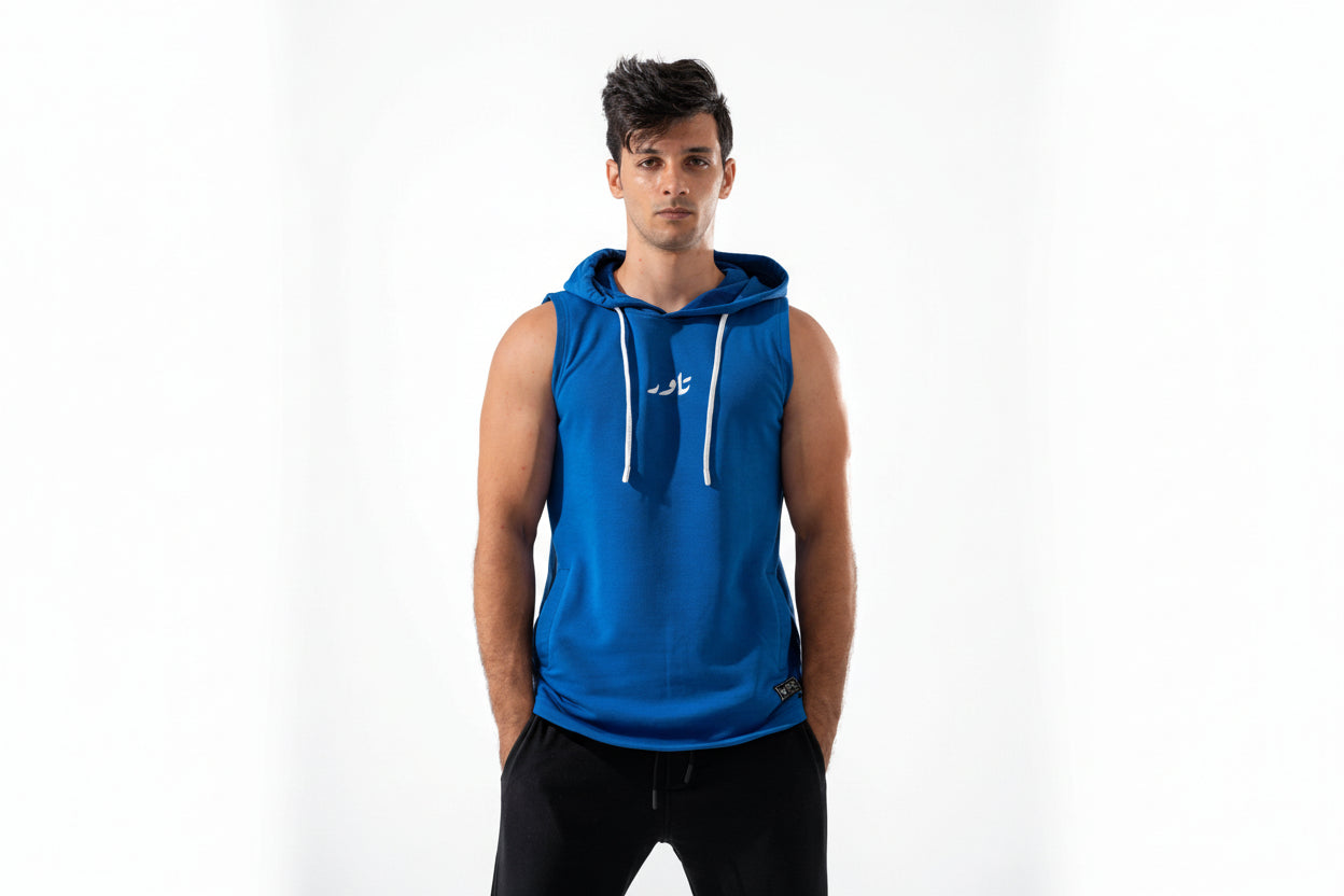Man wearing a blue sleeveless hoodie with a white logo on a white background

