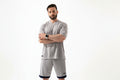 Man wearing a gray athletic outfit with a white background