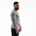 Man wearing a gray long-sleeve athletic shirt on a white background