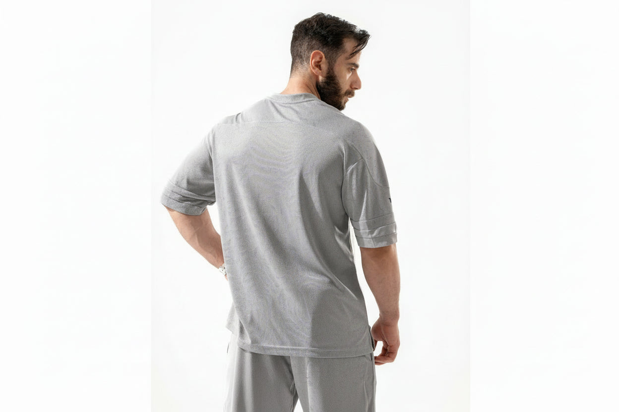 Man wearing a gray outfit on a white background