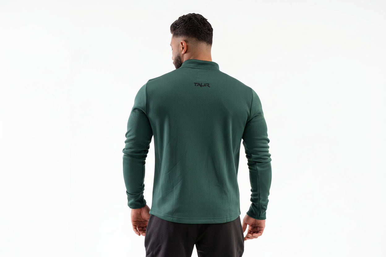 Man wearing a green athletic jacket with a brand logo on the back against a white background