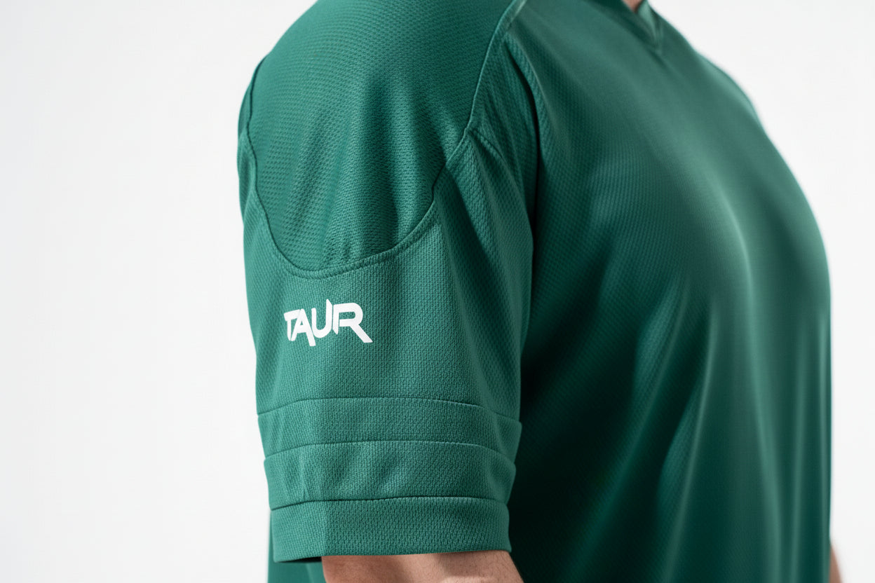 Green athletic shirt with 'TAUR' logo on a white background
