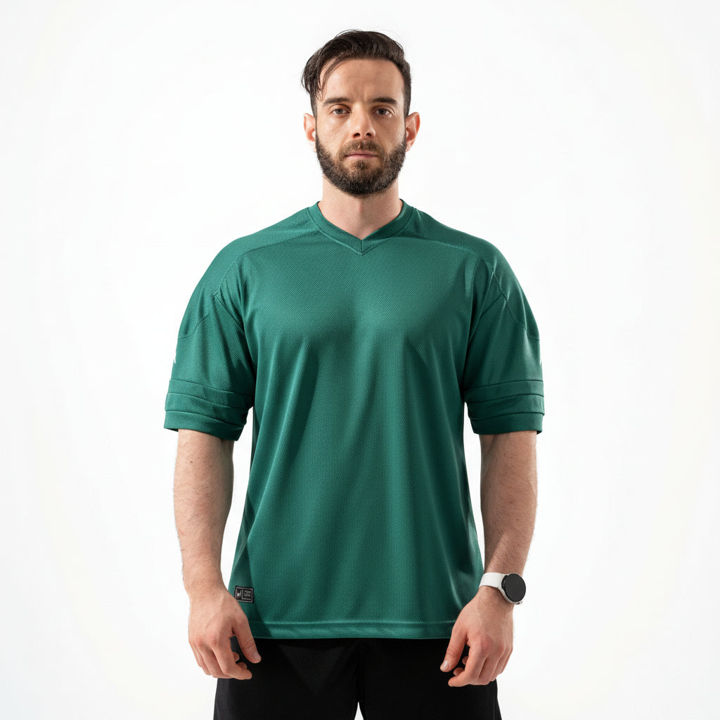Man wearing a green sports jersey on a white background

