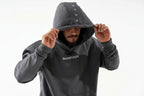 Person wearing a dark gray hoodie with 'BOOSTUREGO' branding on a white background

