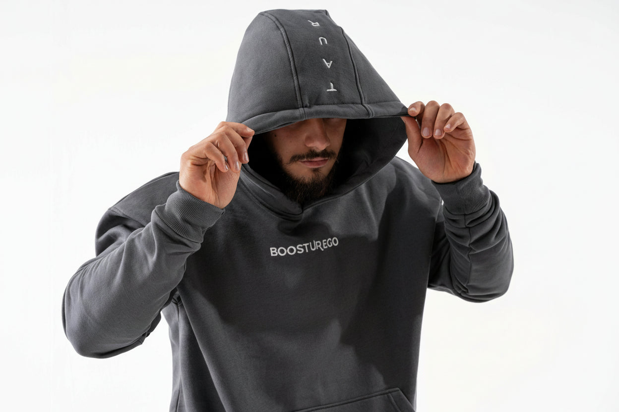 Person wearing a dark gray hoodie with 'BOOSTUREGO' branding on a white background

