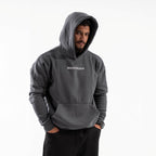 Man wearing a gray hoodie with 'BOOSTUREGO' logo on a white background

