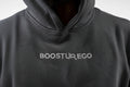 Black hoodie with 'BOOSTUR EGO' logo on a plain background

