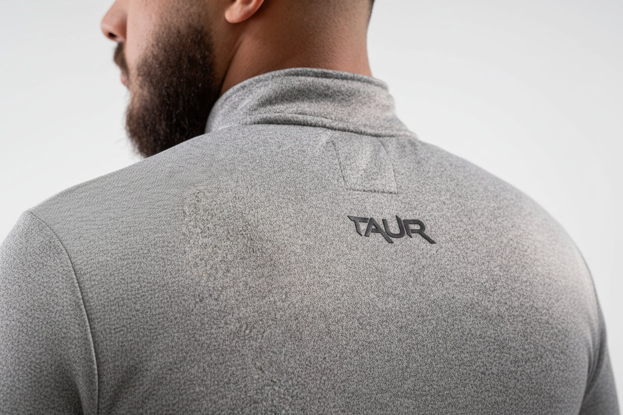 Gray fleece jacket with 'TAUR' logo on the back