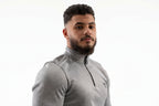 Man wearing a gray athletic jacket on a white background
