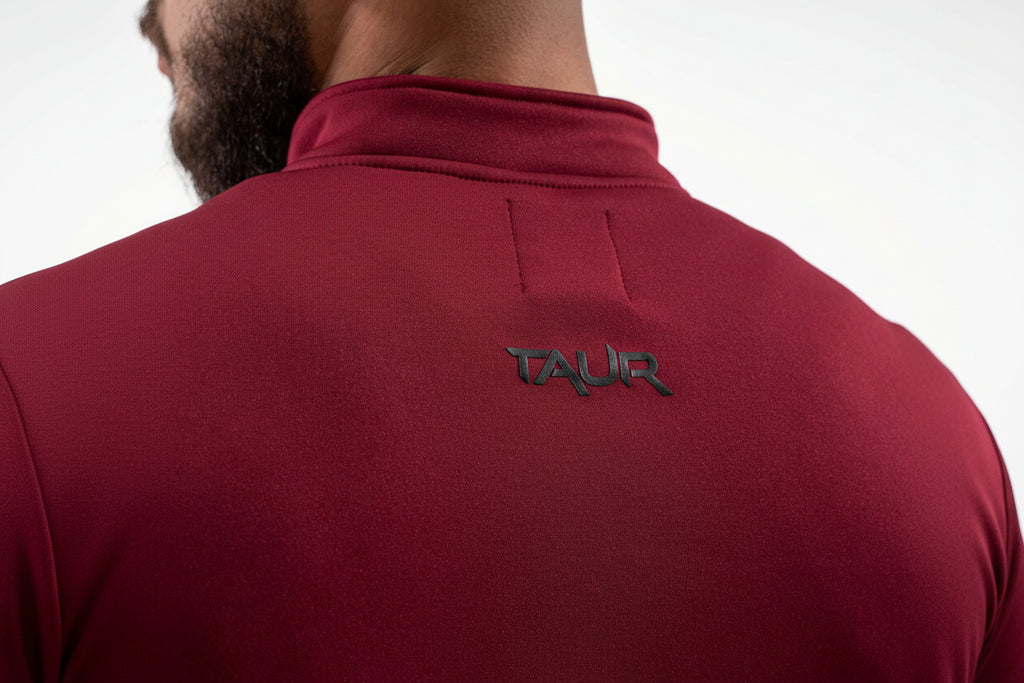 Maroon jacket with 'TAUR' logo on the back against a white background