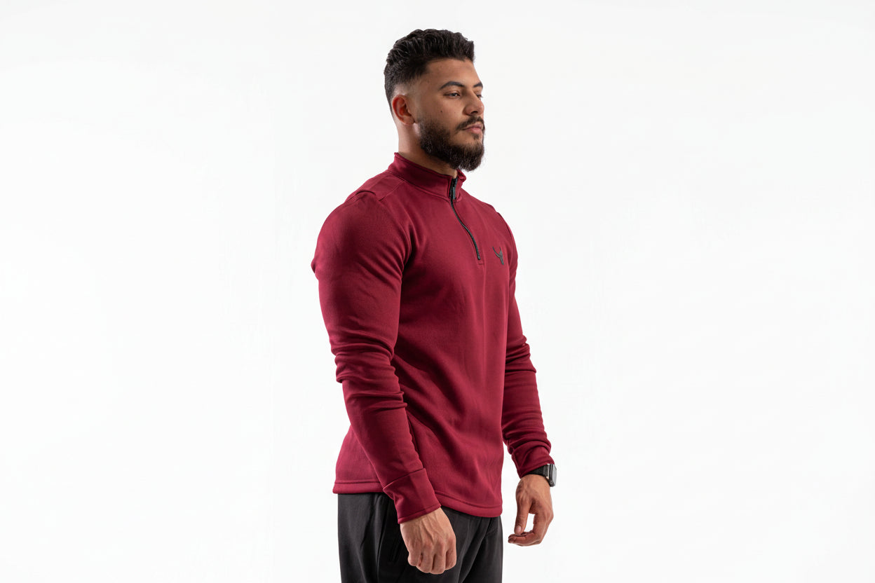 Man wearing a red long-sleeve athletic shirt on a white background