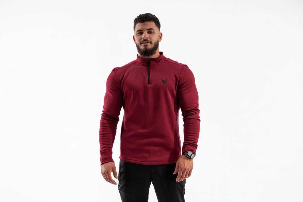 Man wearing a red long-sleeve shirt with a brand logo on a white background