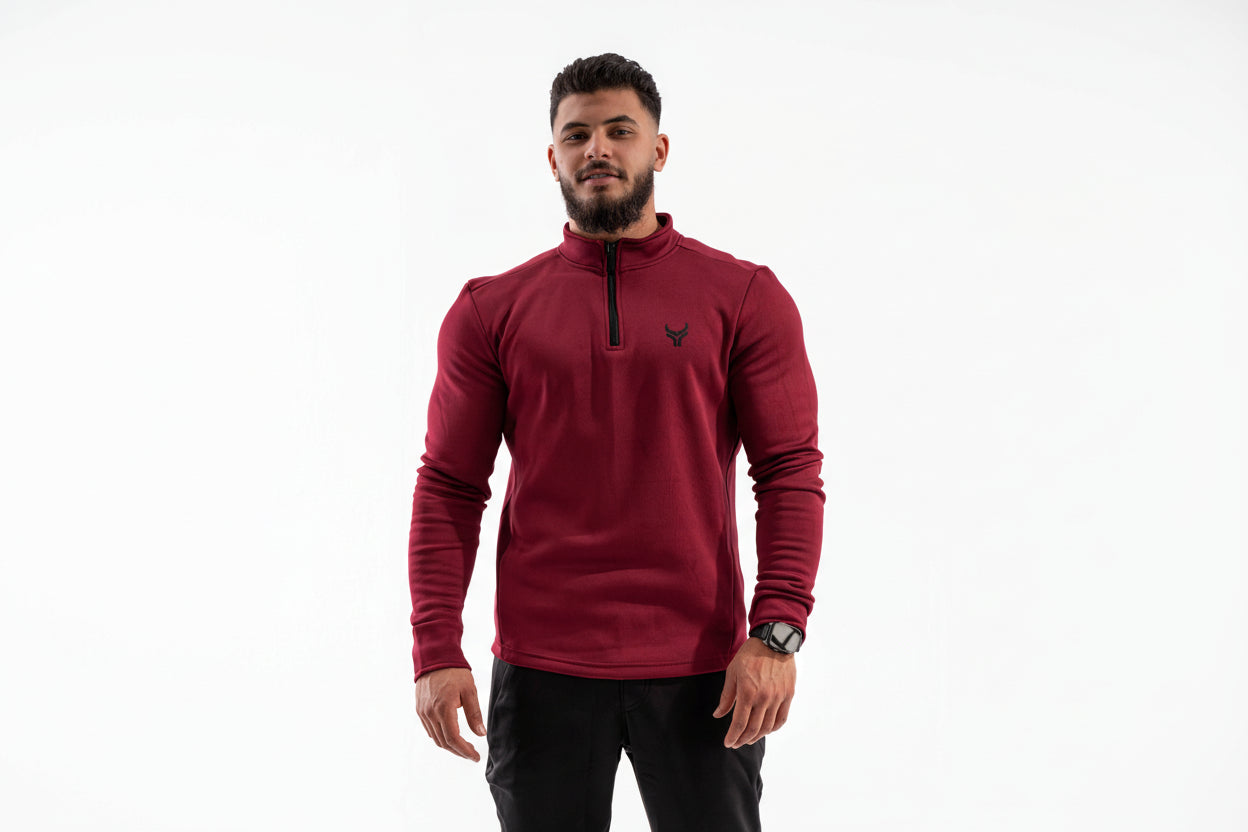 Man wearing a red long-sleeve shirt with a brand logo on a white background