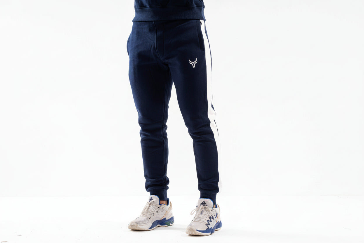 Navy blue jogger pants with a logo on a white background

