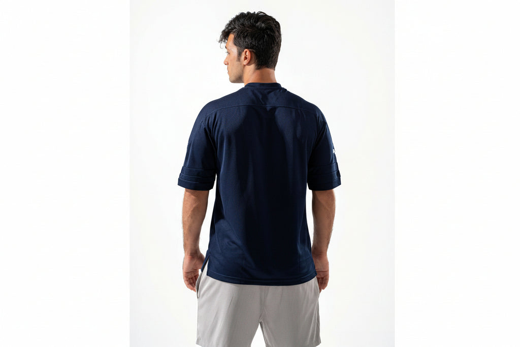 Man wearing a navy blue polo shirt on a white background