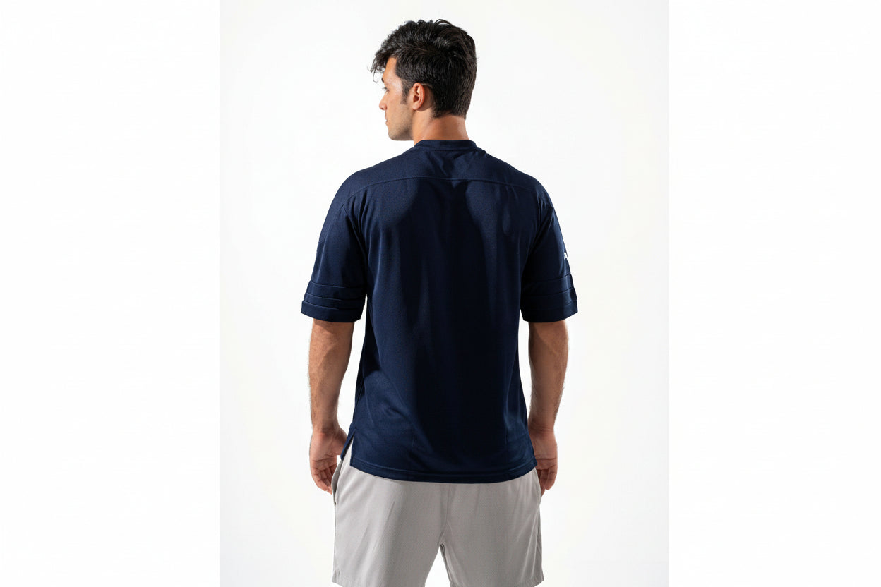 Man wearing a navy blue polo shirt on a white background