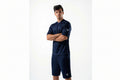 Man wearing a navy athletic outfit with a logo on a white background