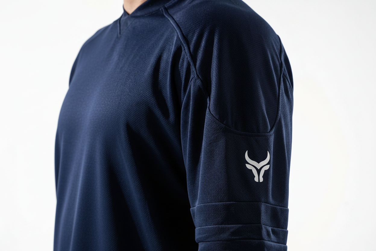 Navy blue long-sleeve shirt with a logo on the sleeve against a white background


