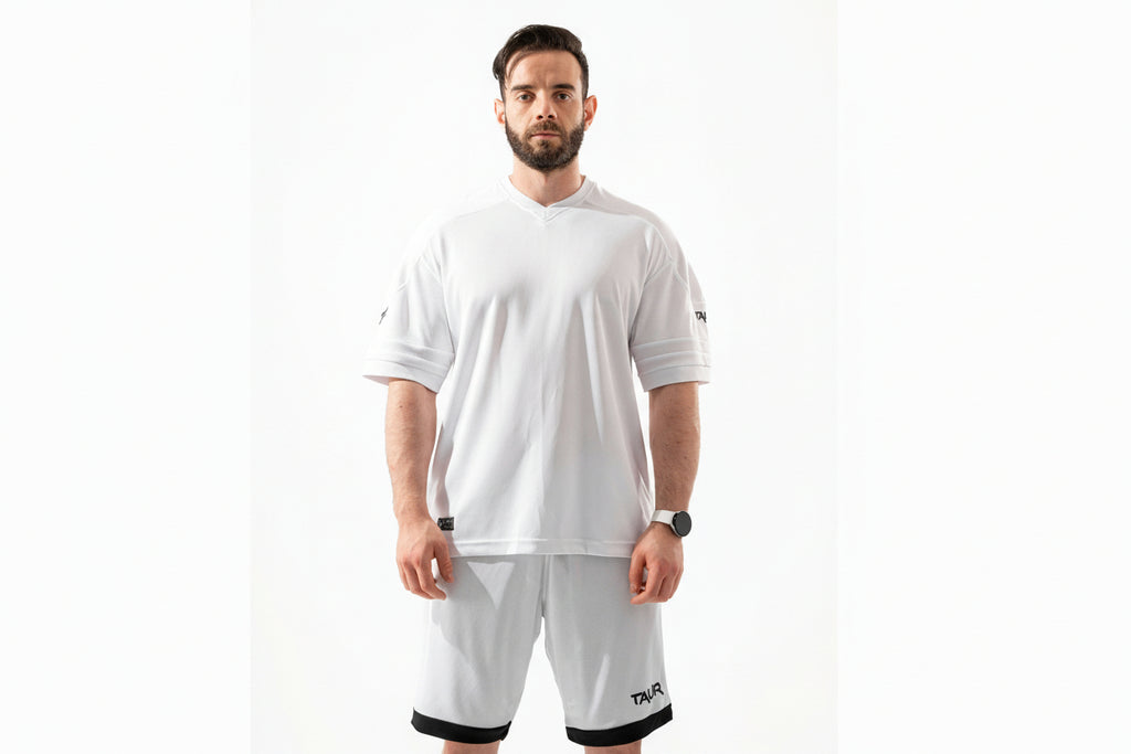 Man wearing a white t-shirt and shorts with a brand logo on a white background

