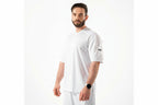 Man wearing a white t-shirt with a logo on a white background

