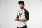 Man wearing a black and white athletic outfit with a logo on a white background
