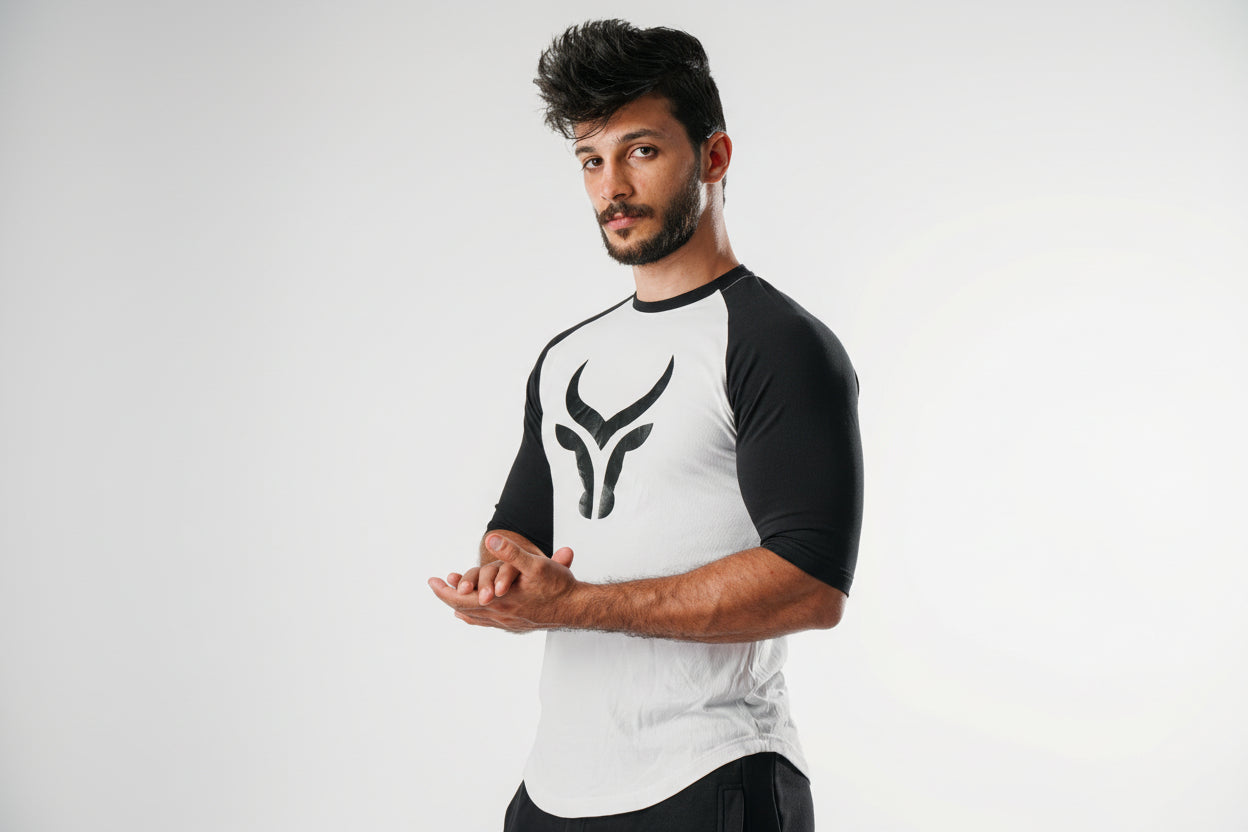 Man wearing a black and white athletic outfit with a logo on a white background
