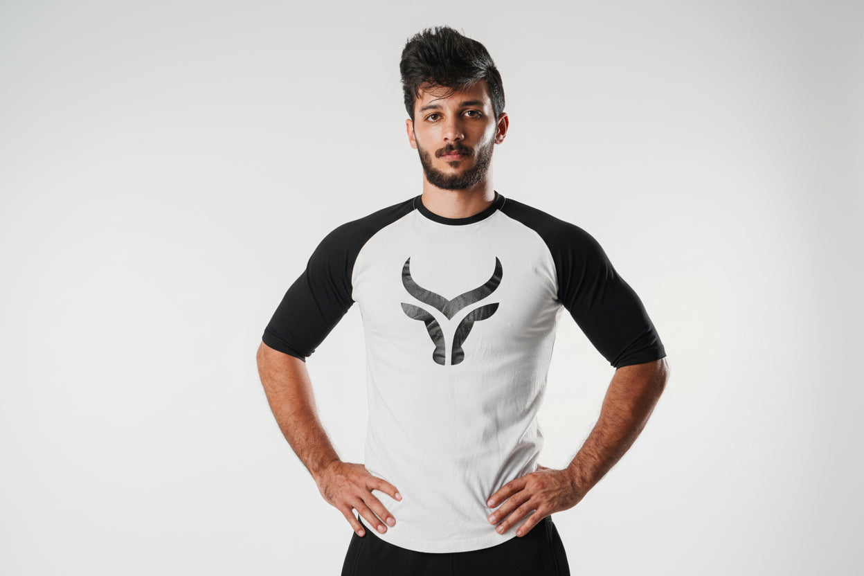Man wearing a black and white baseball shirt with a logo on a plain background

