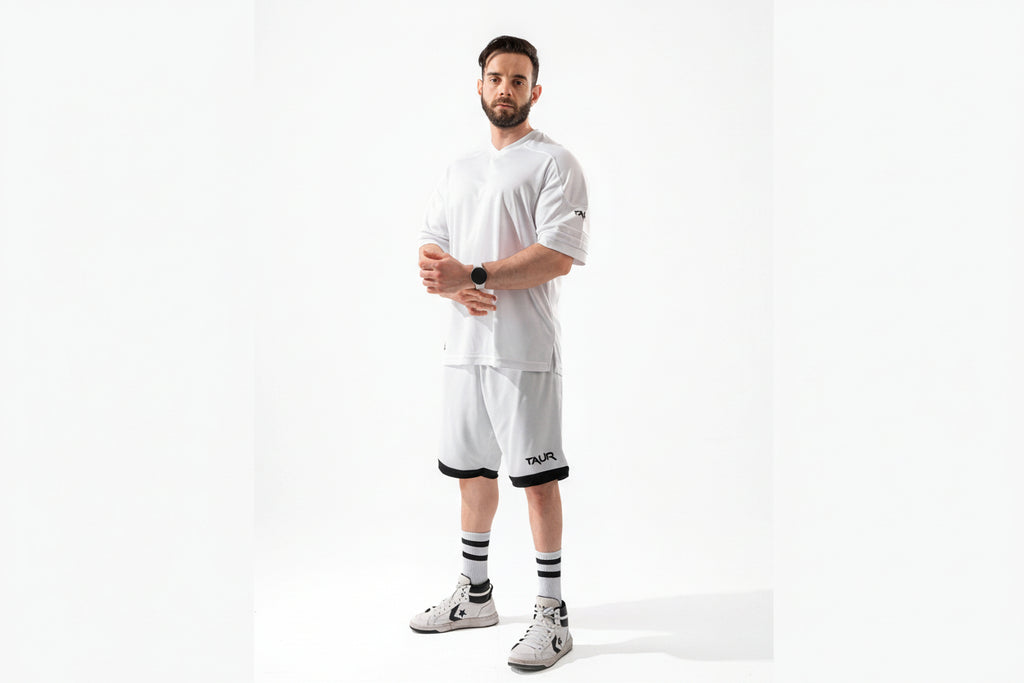Man wearing a white outfit with black accents on a white background