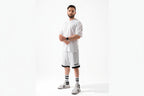 Man wearing a white outfit with black accents on a white background